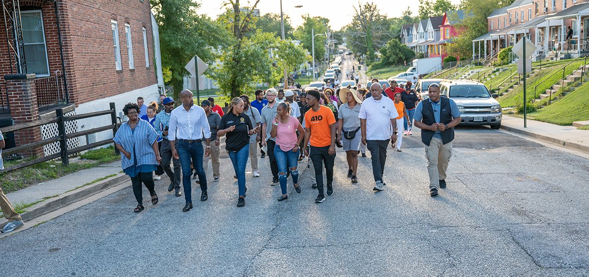 District 4 community engagement walk - Mayor Scott walking with citizens down the road